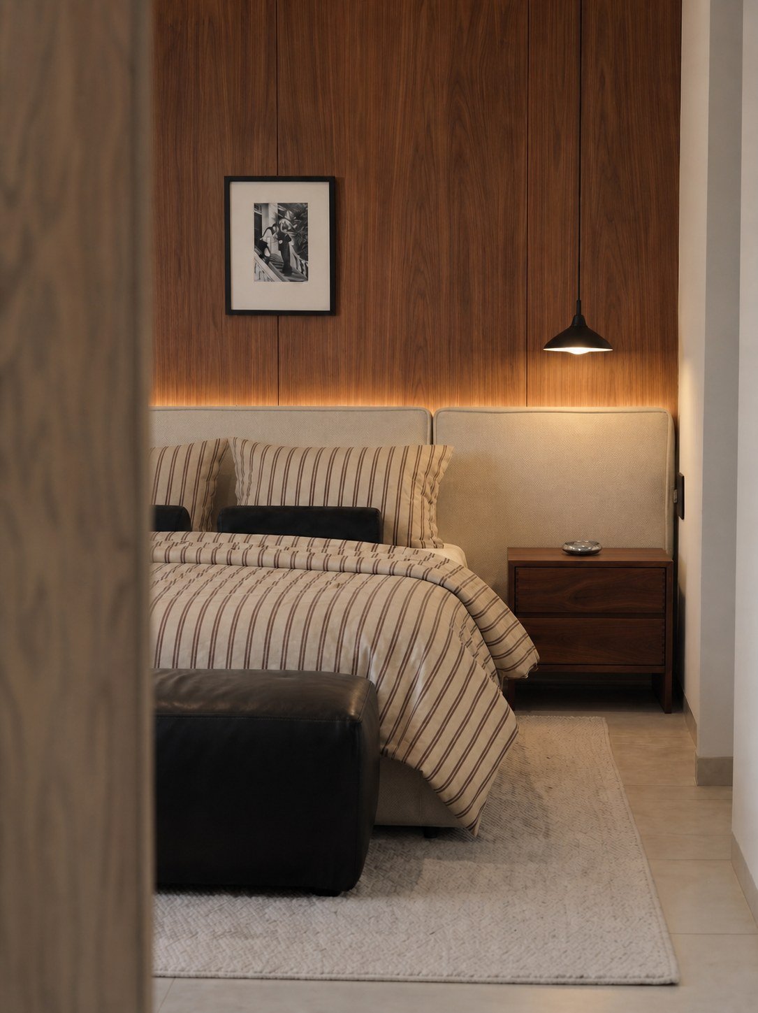 Bedroom with a walnut-paneled wall